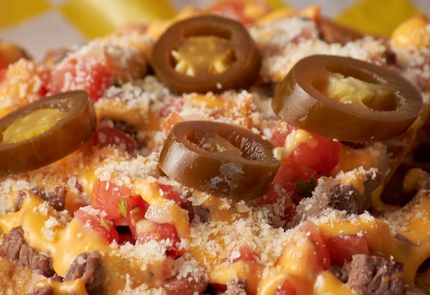 close up shot of nachos with jalapeno