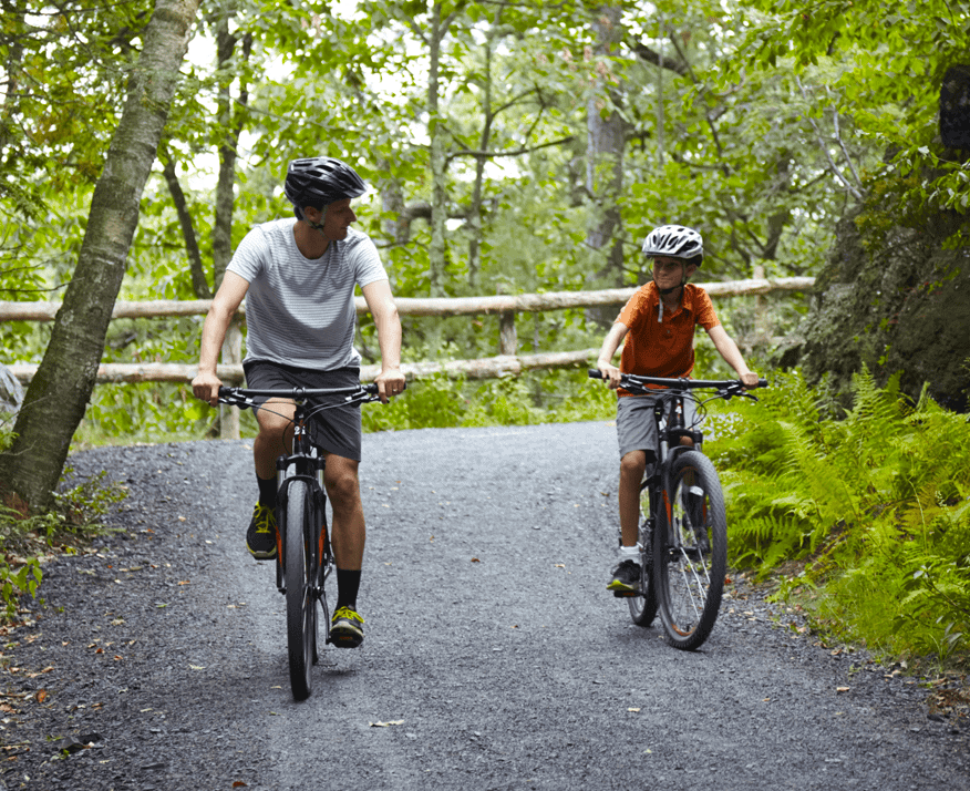 Man Mountain Biking Our Trails with His Son