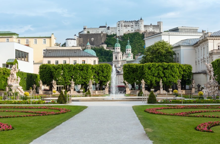 Gardens of Mirabell Palace with a fountain and statues