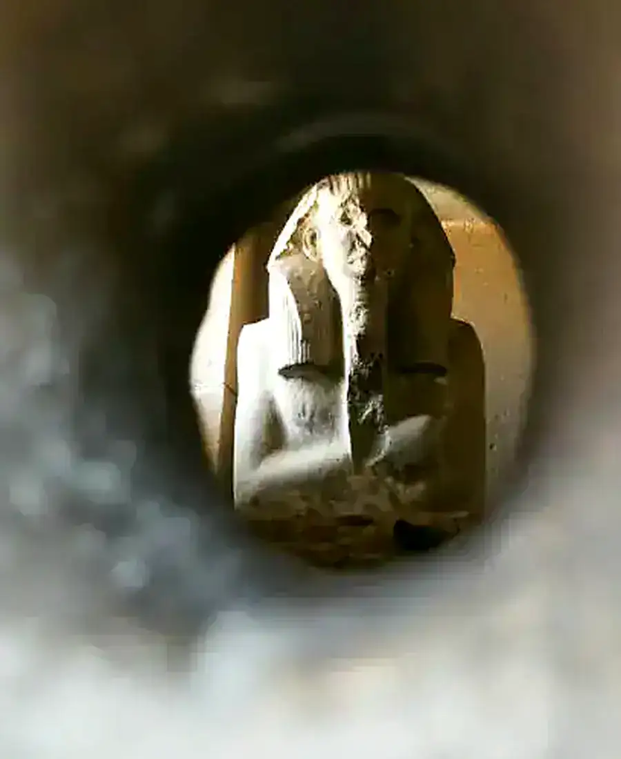 Statue of King Djoser viewed through the serdab opening
