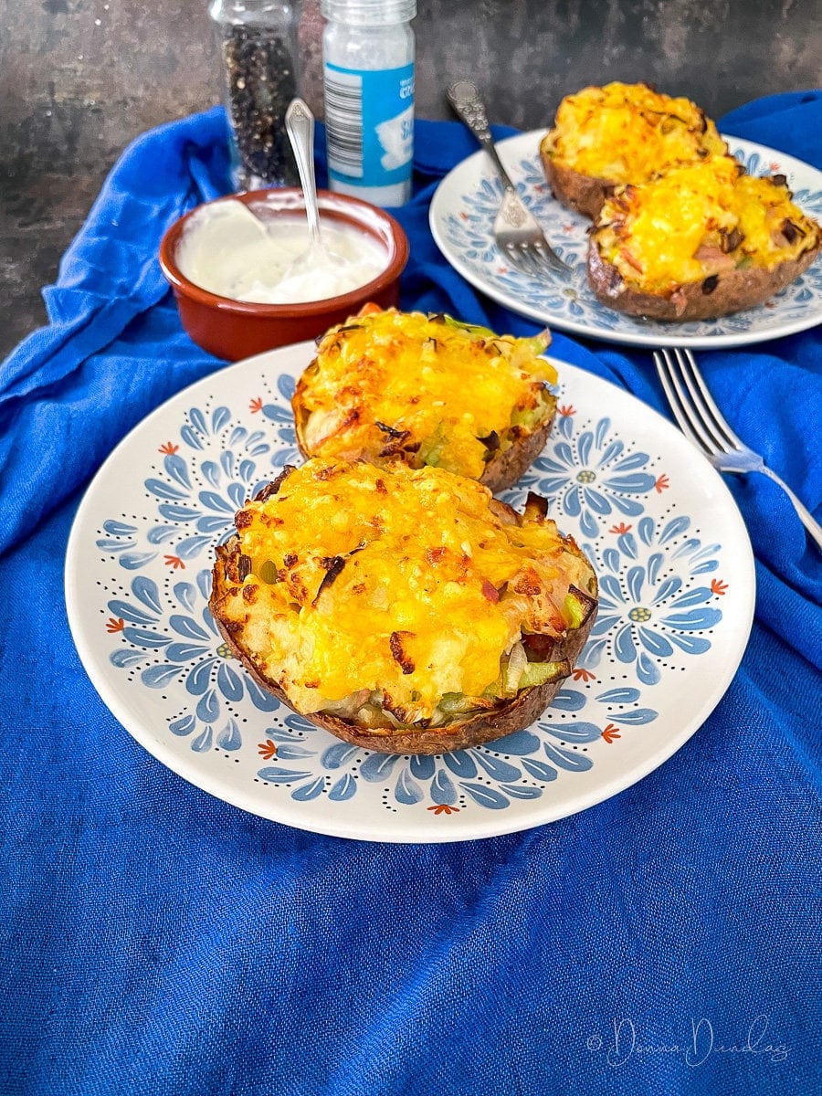 air fryer loaded potato skins on plate.