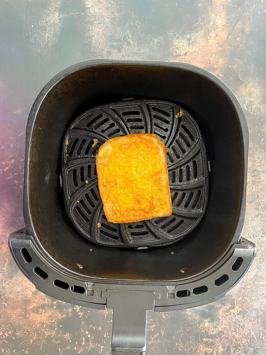 toastie in air fryer basket.