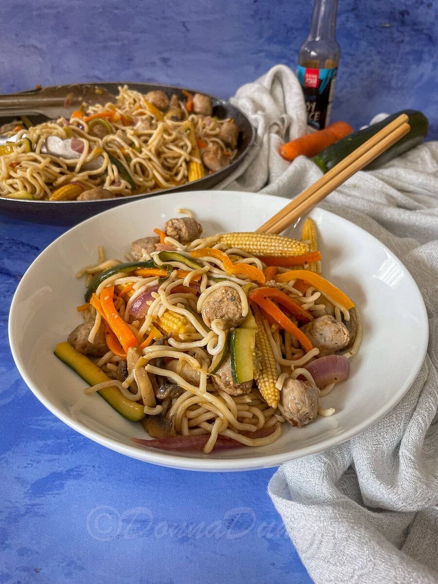 side view of bowl of sausage stir fry.