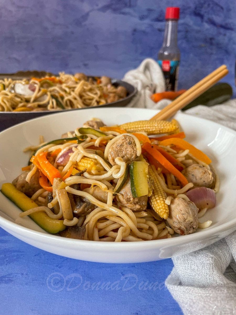 side view of bowl of sausage stir fry.