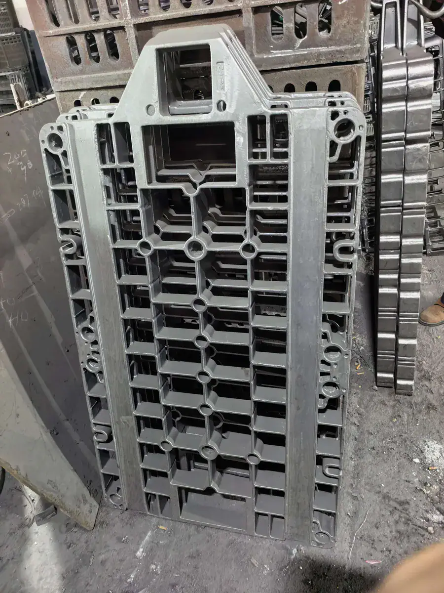 Rectangular cast furnace base tray standing upright in a workshop