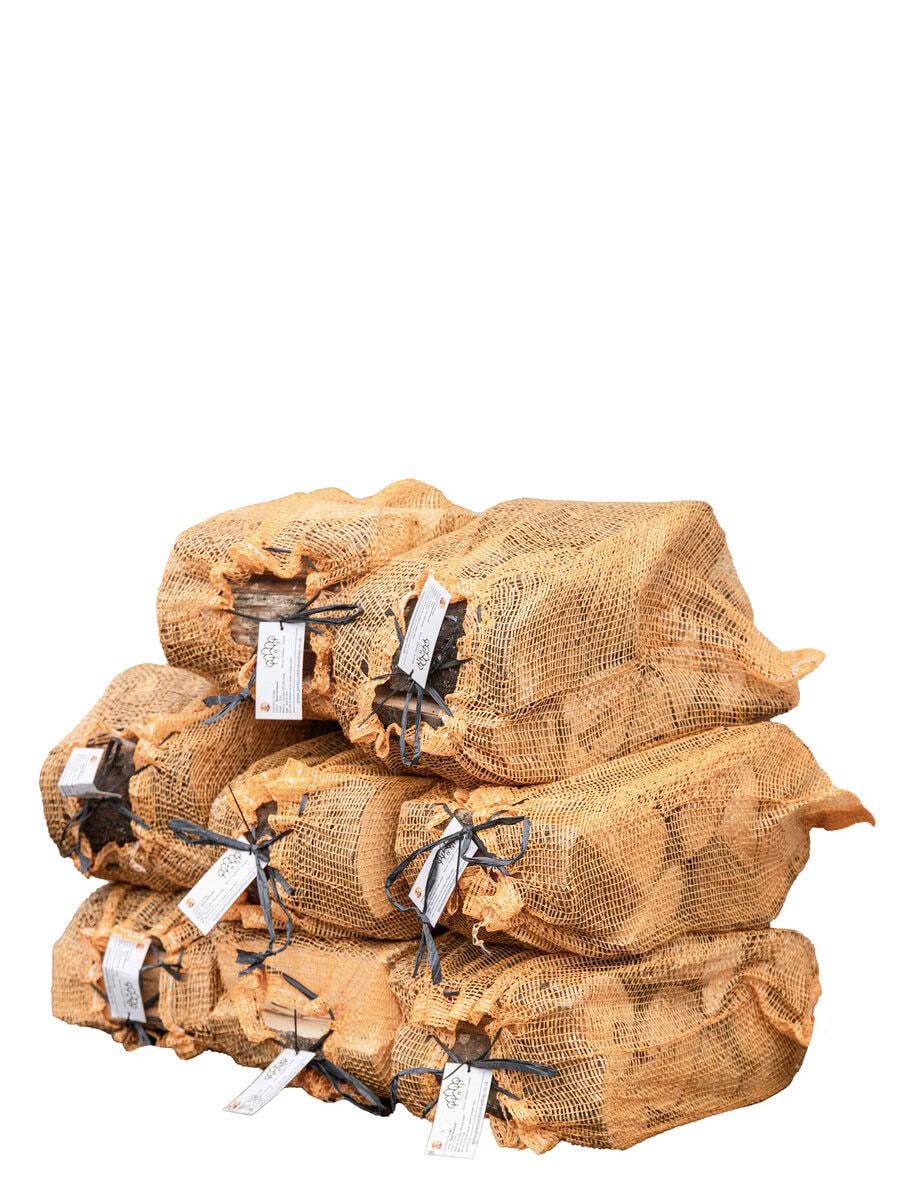 Kiln-dried mixed hardwood logs stacked in bags for sale.