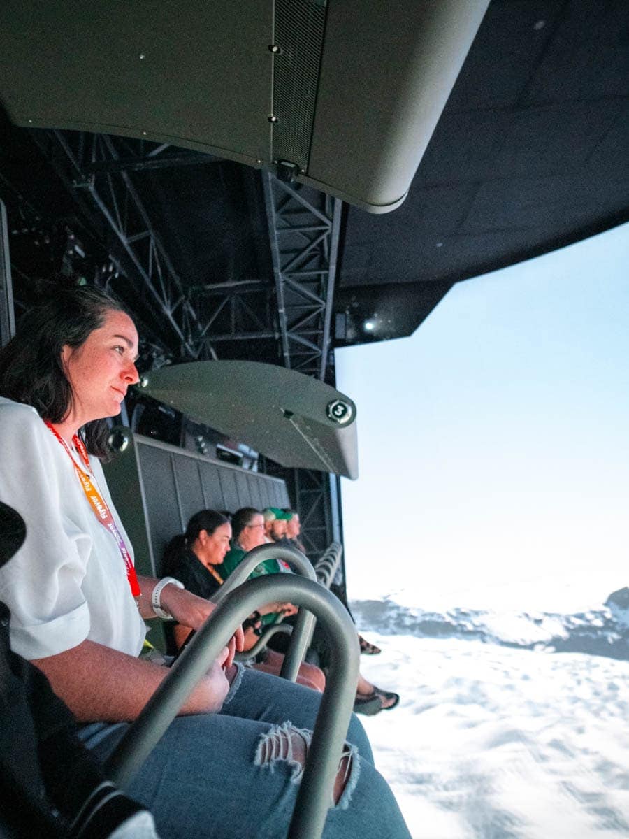 Heather from ArboursAbroad sitting on the Flyover Las Vegas ride as she soars over the mountains.