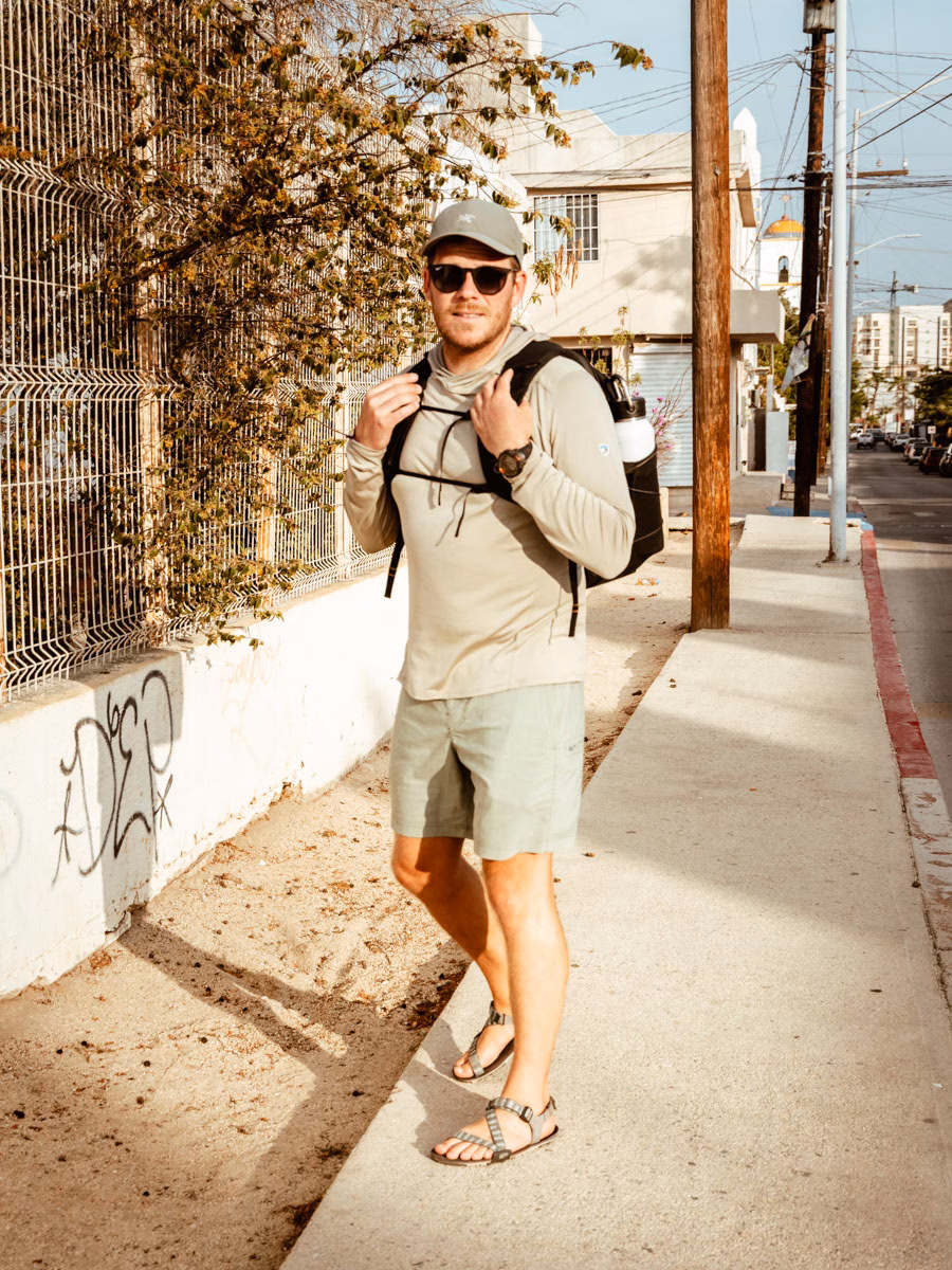 Jason standing on a street in Cabo san Lucas, Mexico wearing his sun hoodie.