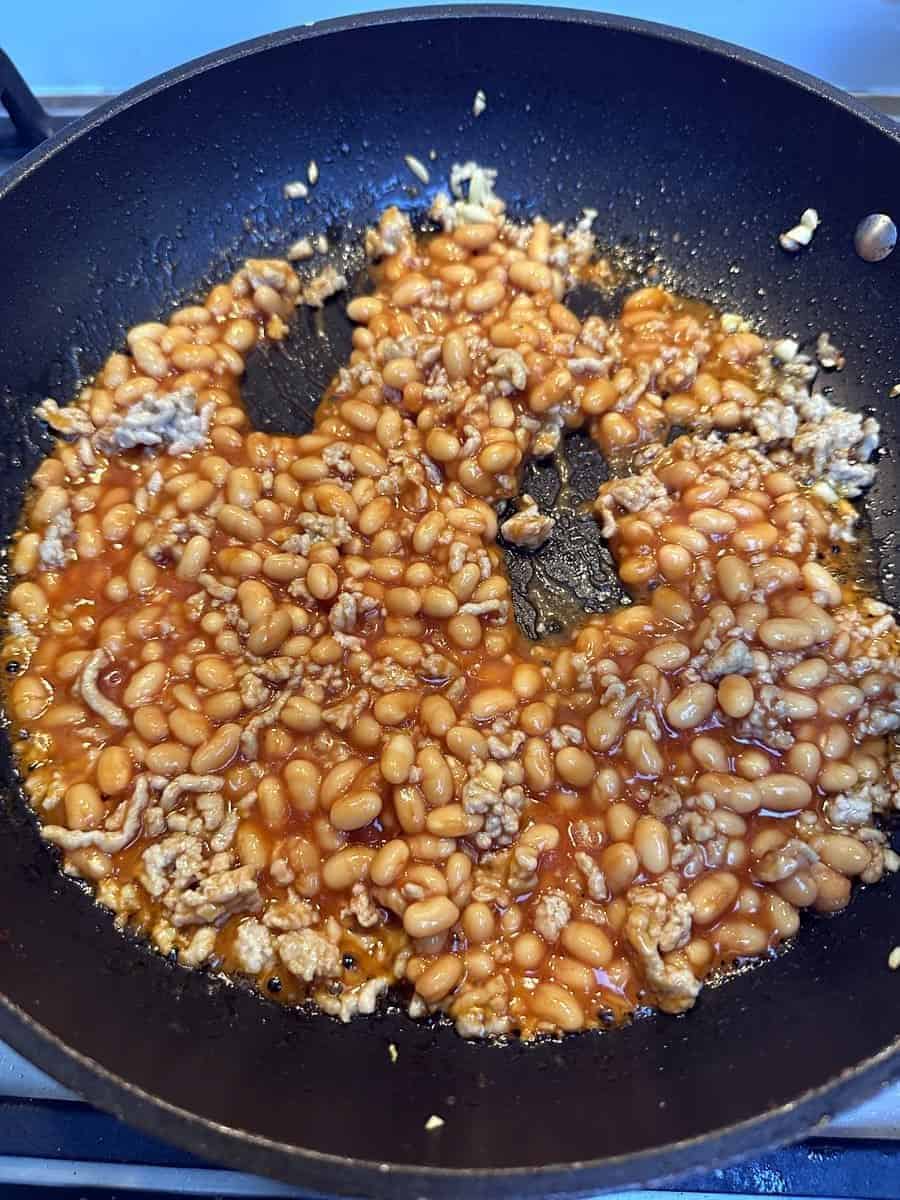 Then add the baked beans and cook until it is all heated through