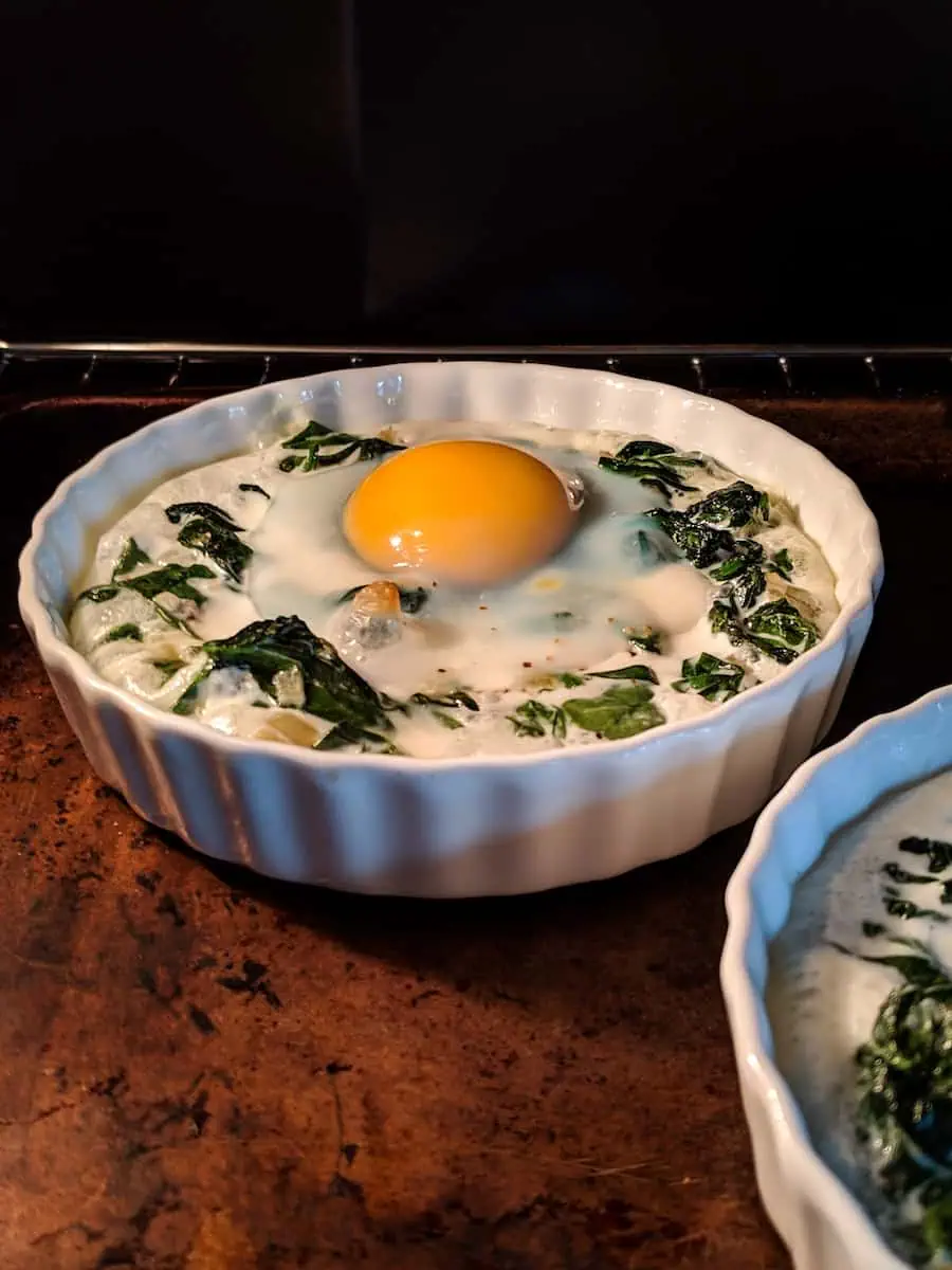 baked eggs in ramekins with spinach and cream