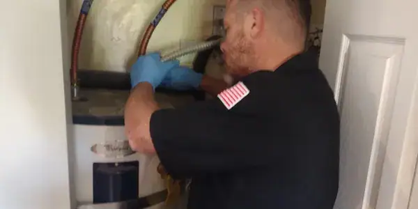 Licensed plumber inspecting a residential plumbing system