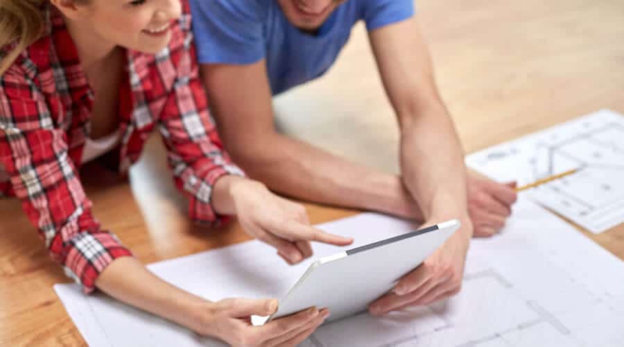 Couple looking at Reality Homes Floor Plans