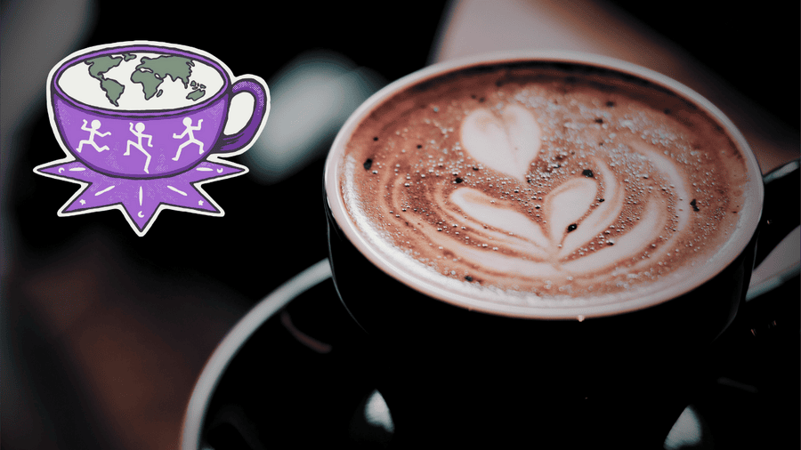 : A cortado served at Klekolo World Coffee in Middletown, CT, featuring heart-shaped latte art in a black cup, with Klekolo’s purple logo of a coffee cup and running figures overlayed on the side.