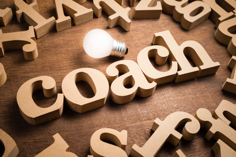 Coach The word coach with a light bulb going off