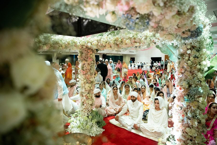 Guests dressed in white at a Namdhari Sikh wedding ceremony in Bangkok