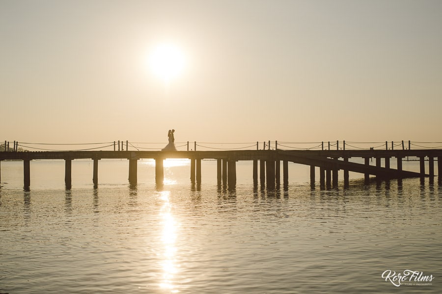 Western Wedding Kiss on the bridge in the setting sun silhouette at Bang Pu Recreation Centre