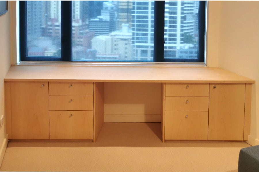 This custom made desk was part of a home office we made for a client in Kent St, Sydney CBD. Made from sycamore veneer with chrome handles to match other joinery that is in client's home. Built to fit with-in the angled walls in this apartment.