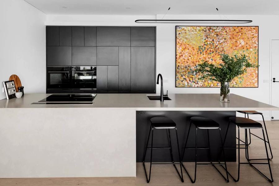Designed with the customer brief for a minimalist style with a monochromatic colour pallet. We achieved this with the use of black cabinets, white walls, and the Quantum Quartz Concrete Matte benchtop The clean minimalist design with integrated appliances and no handed.