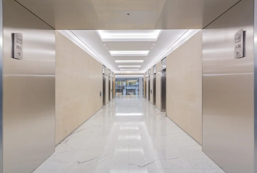 View through the lift lobby in the offices at 20 Fenchurch st, with directional signs on the wall at the entrance