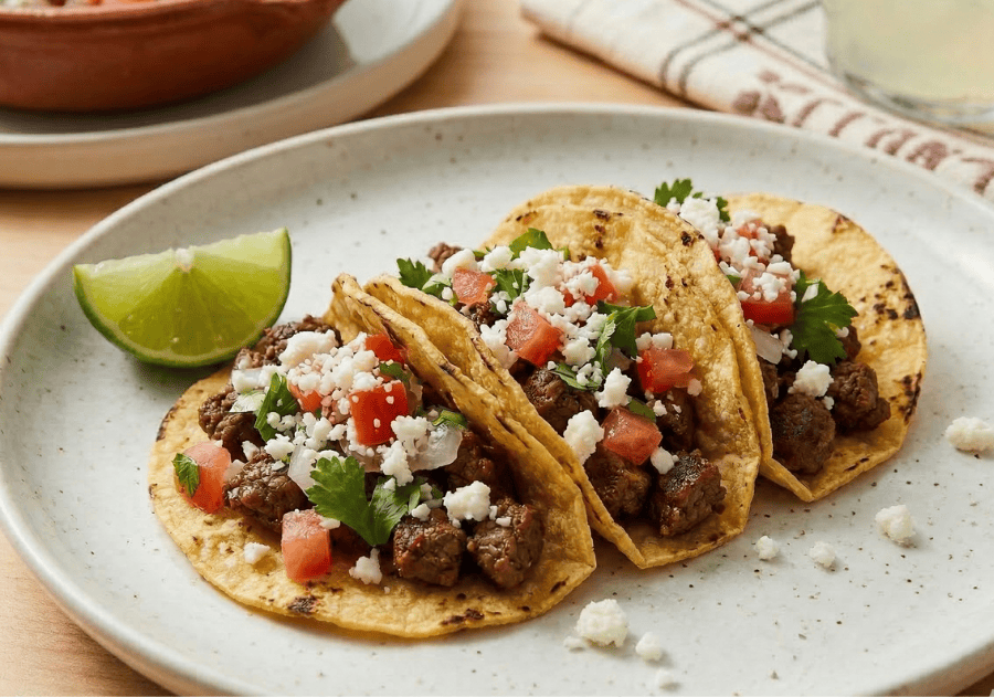Carne Picada Tacos on a plate with a lime. 