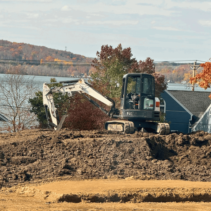 RCS excavator grading a lot by the lake