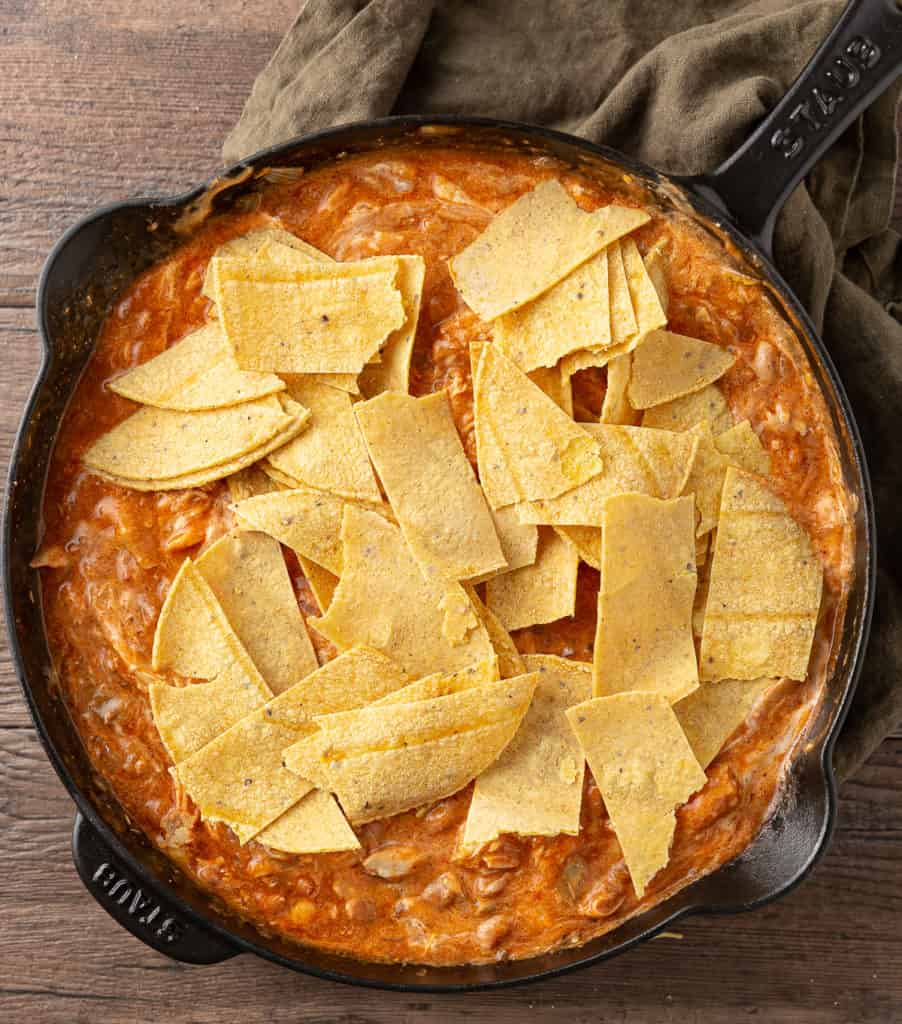 enchiladas made in skillet with sliced tortillas