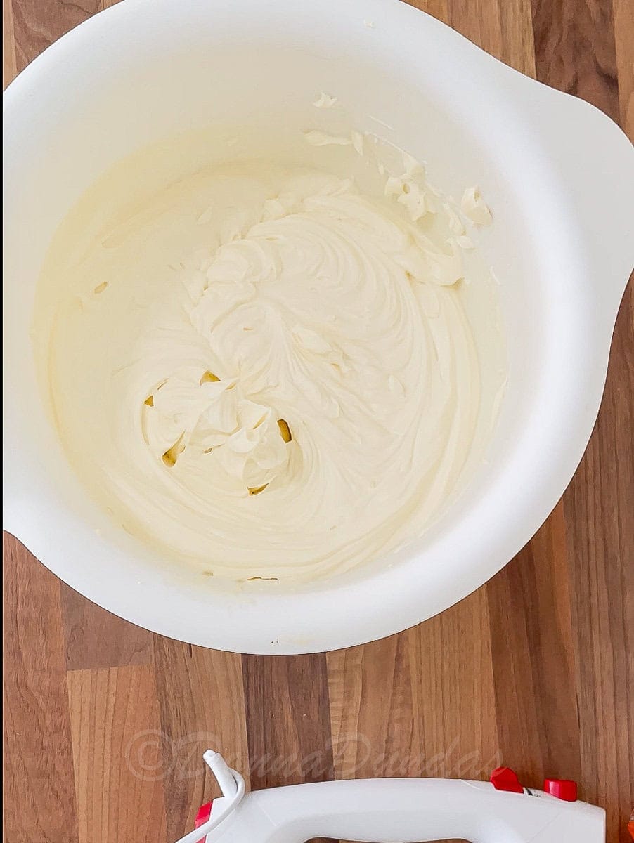 cream whisked to thick peaks in mixing bowl.