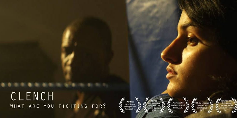 Award-winning short film banner featuring a dramatic, cinematic scene of a man staring at a woman sitting in a gritty boxing gym.