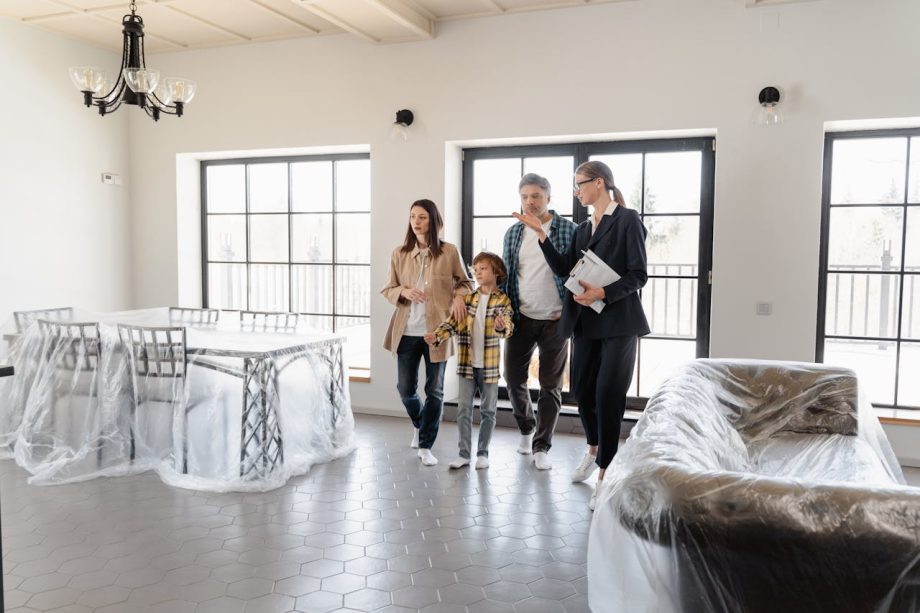 family exploring future home with real estate agent