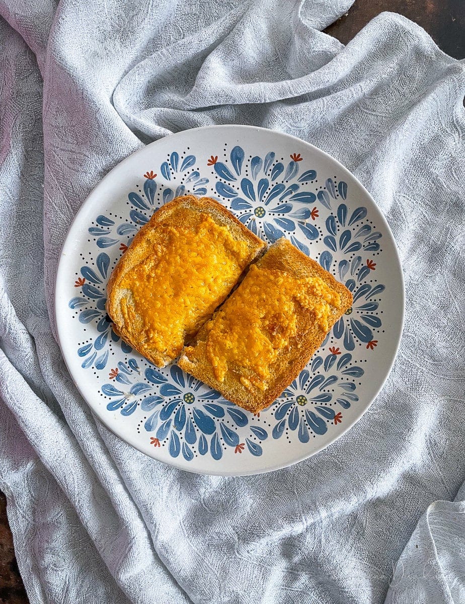 toastie with cheese on blue patterned plate.