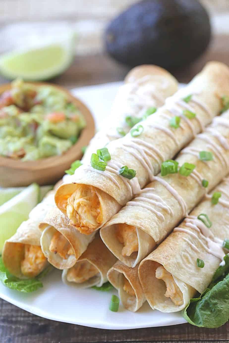 These Baked Buffalo Chicken Flautas as crispy, cheesy and full of buffalo chicken flavor. Feed a crowd this Cinco de Mayo with these delicious Baked Buffalo Chicken Flautas.