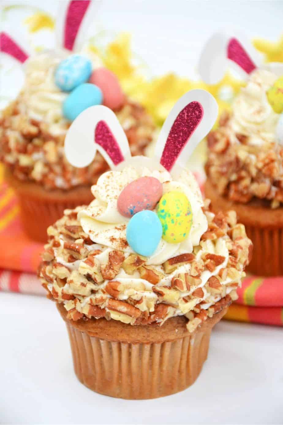 Enjoy the taste of these sweet, flavorful baked treats just in time for the Easter holiday with this recipe for Carrot Cake Bunny Cupcakes. Not only do they taste delicious, but they’re also so much fun to prepare! These Easter cupcakes are extra moist with a rich and silky cream cheese frosting swirled on top. These easy cupcakes are perfect for an Easter party or to serve as an Easter dessert after dinner.