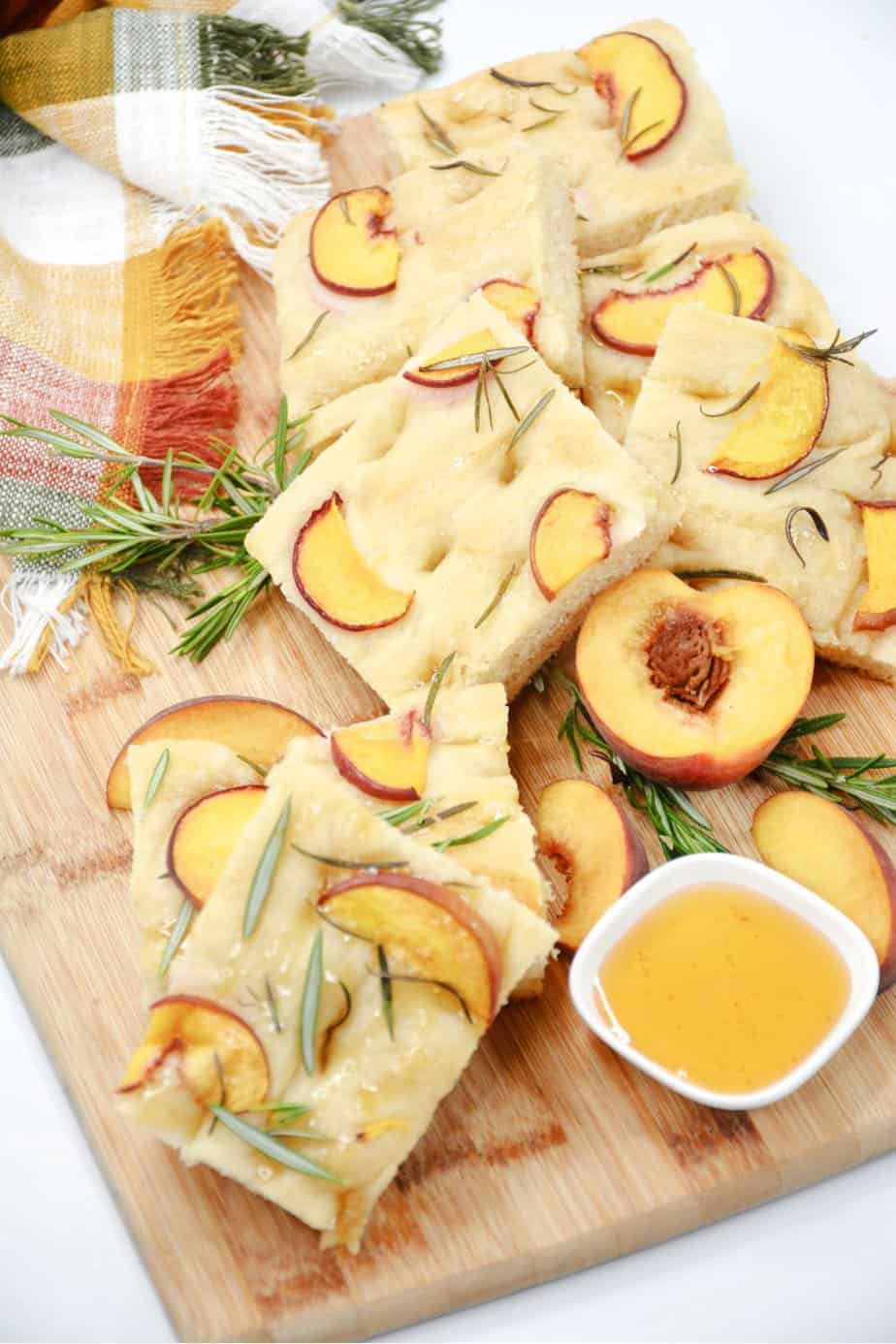 Prepare a light and refreshing treat with this delicious Peach & Rosemary Focaccia Bread. It has the perfect naturally sweet touch with peaches, making it the perfect quick snack to enjoy! Focaccia bread, the Italian-style bread. With this recipe for Peach & Rosemary Focaccia Bread, you’re combining two incredible flavors into one to make bread that has a light, sweet taste and amazing texture that keeps you coming back for more.