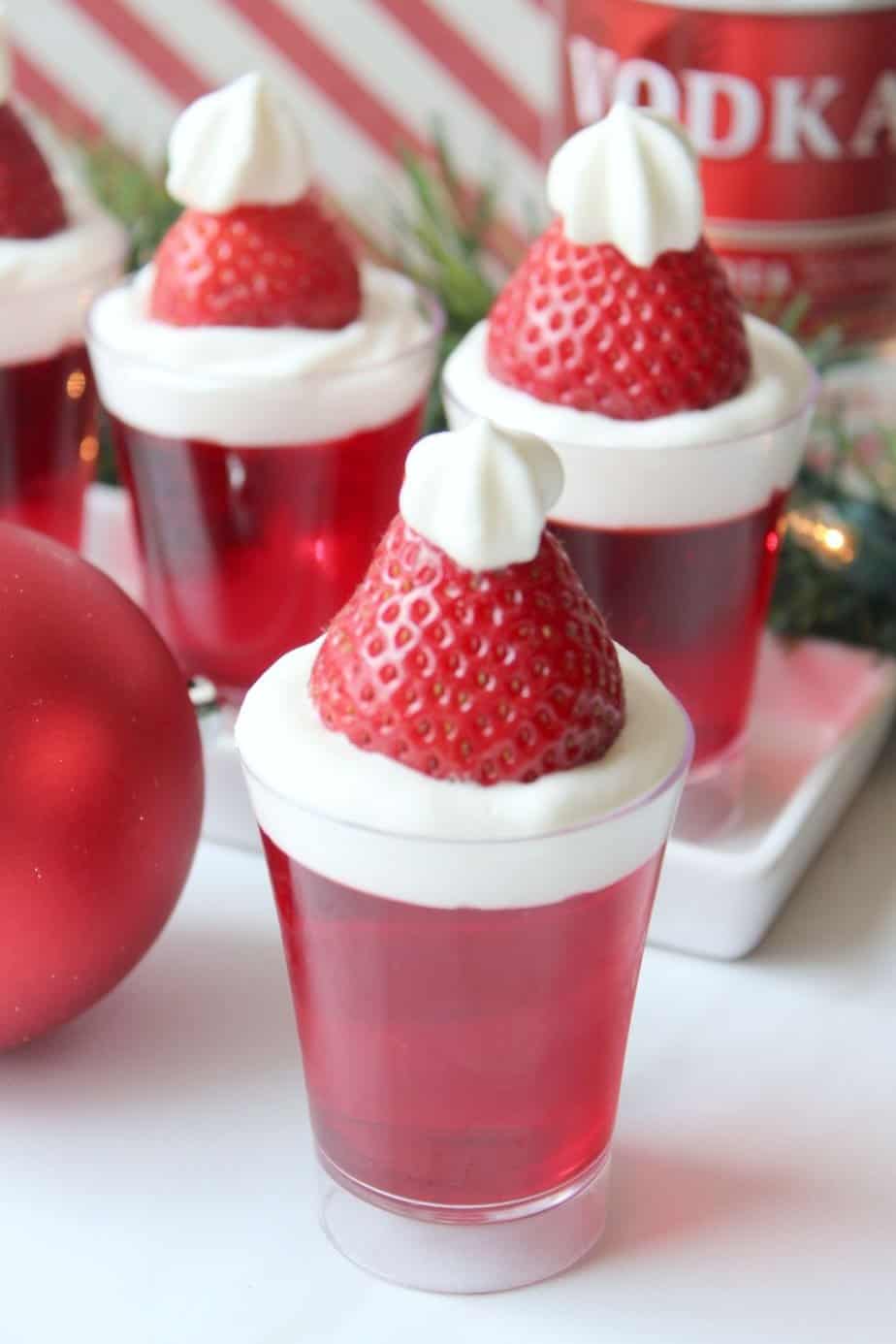 Bring in the celebration during the holiday season with these Santa Hat Jello Shots. This fun Christmas Jello Shot recipe tastes absolutely amazing! This easy jello shot recipe is a perfect holiday party recipe idea.