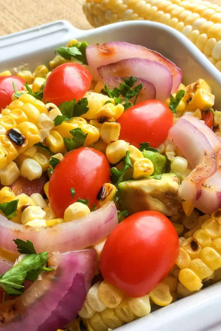 Ditch the typical pasta salad and go for something lighter and refreshing with this delicious grilled Corn Tomato Salad recipe. It’s the perfect summer side to serve. This easy summer salad pairs two stars of the season - corn and tomatoes, making this healthy salad recipe a winner.