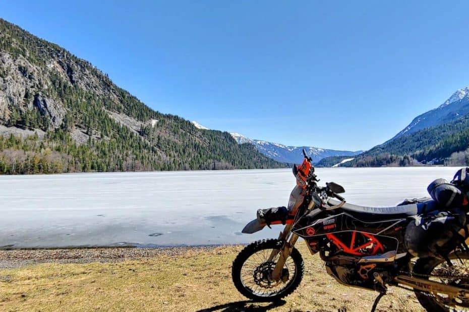 a picture of a frozen summit lake with motorcycle