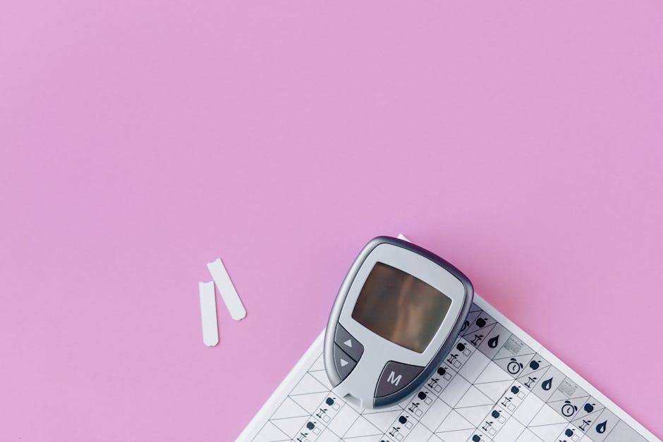 Flat lay of a blood glucose monitor and test strip