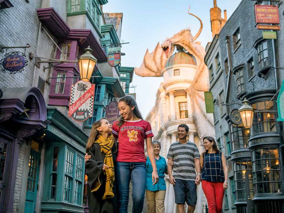 Colorful Universal Studios themed street with a giant dragon prop, families enjoying a fun day at 407 and Beyond Vacation Co.