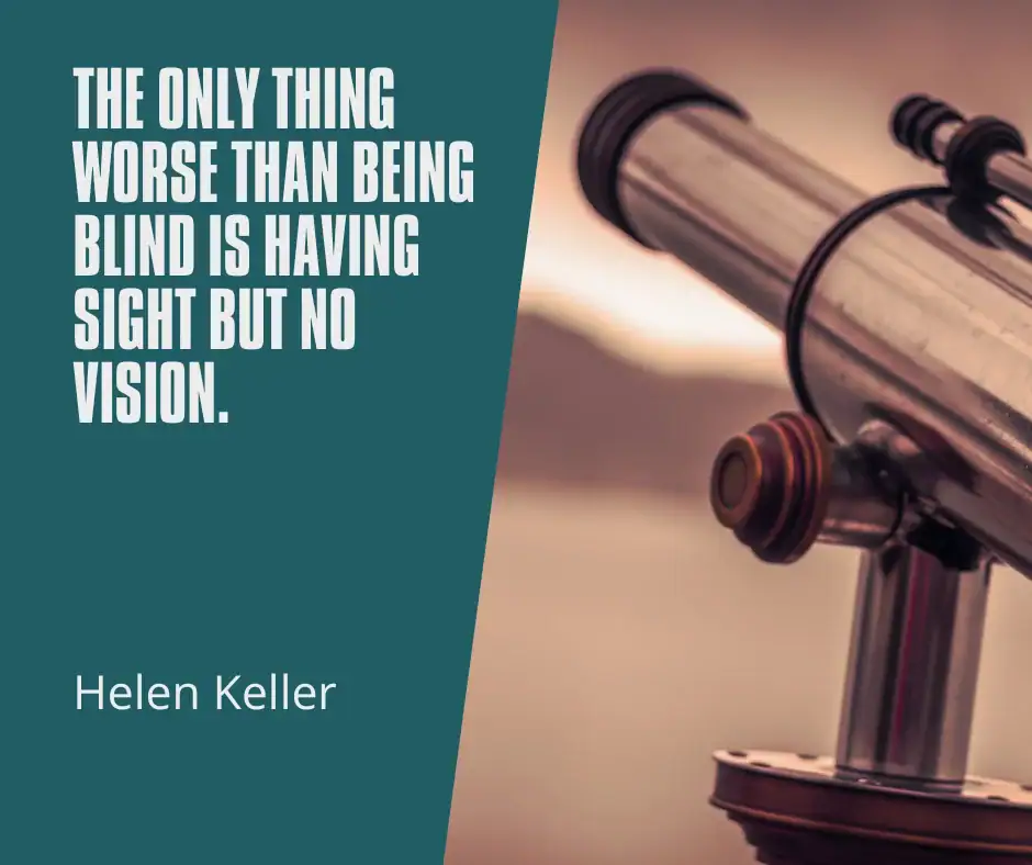 Hands arranging images and words on a vision board to create a collage of aspirations and goals