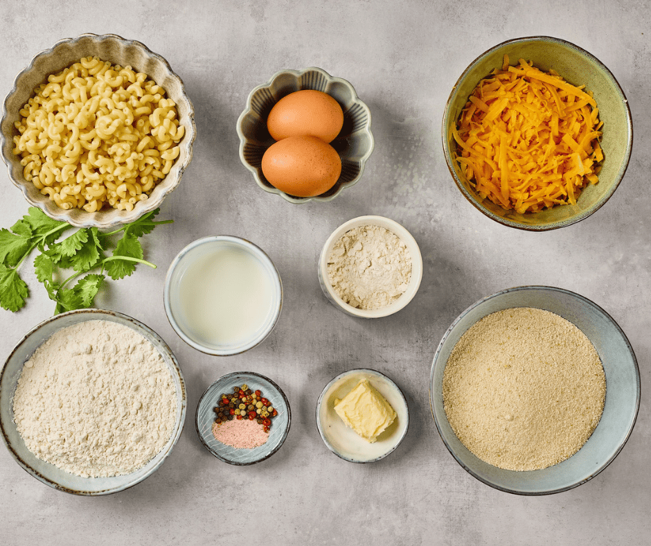 ngredients for homemade Mac and Cheese Bites including elbow macaroni, shredded cheddar, eggs, flour, and panko breadcrumbs.