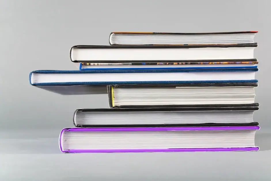 Focused and concentrated reader immersed in a stack of books