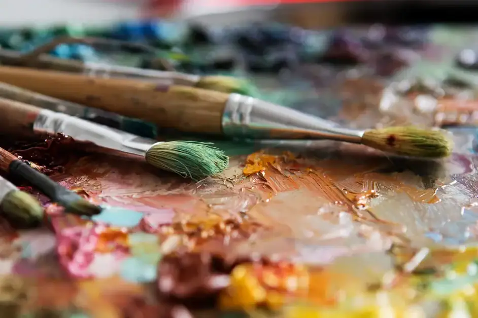 Paint brushes and a canvas on a table