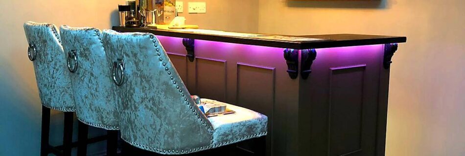 Our Abbey bar with pink fluorescent lighting around it