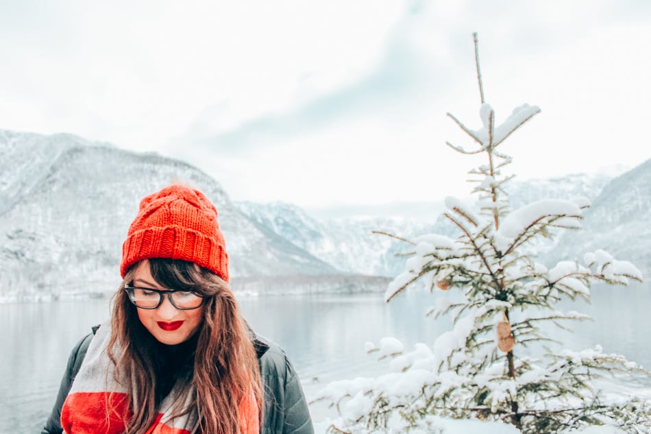 Lia in red lipstick on a snowy day in Hallstatt, Austria