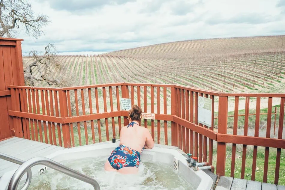 Soaking in a spring-fed hot tub at River Oaks overlooking vineyards in Paso Robles, California.