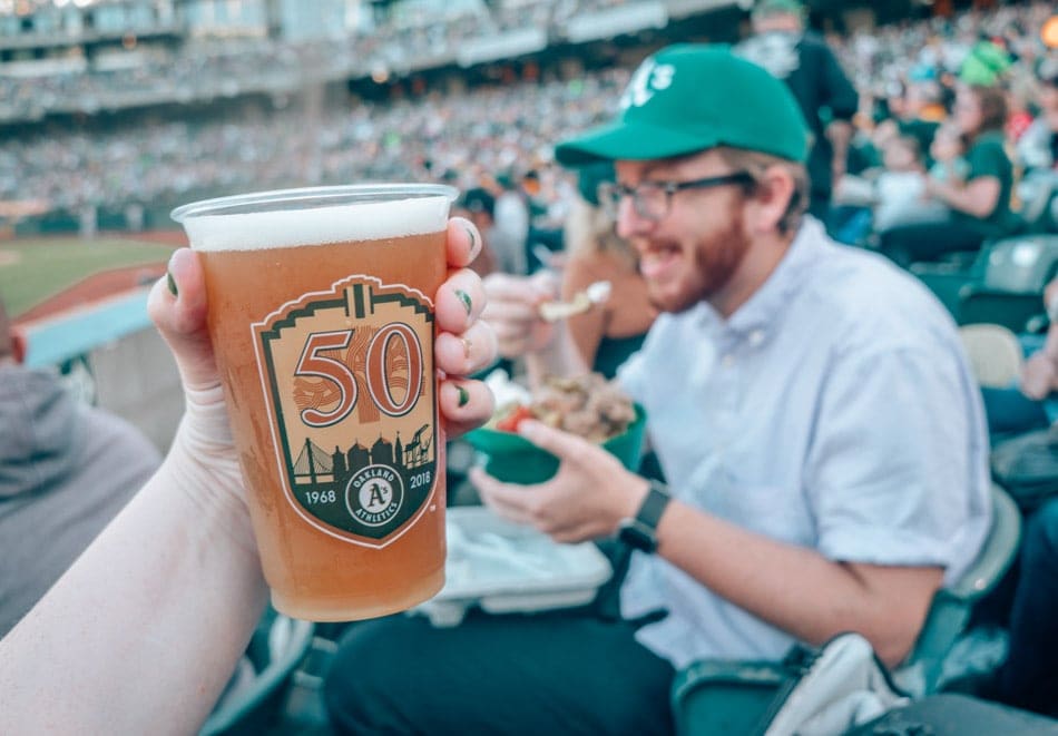 Oakland Athletics 50th Anniversary beer cup at a baseball game in Oakland, California. One of the best things to do in Oakland.