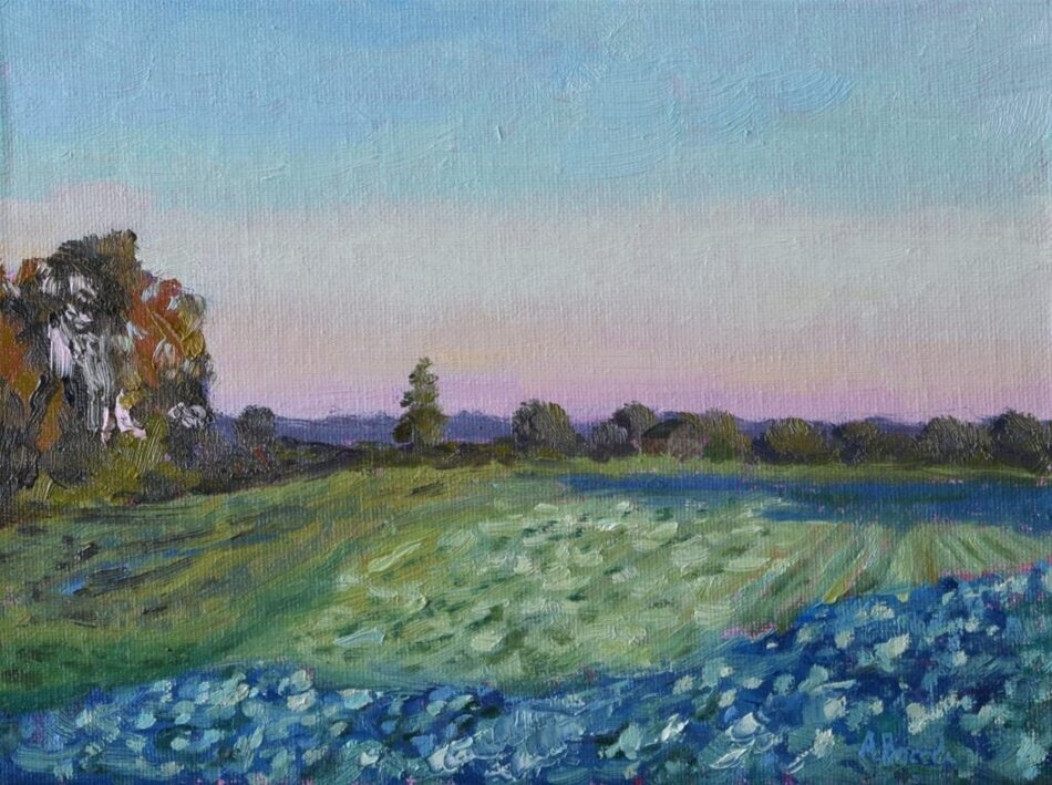 Original plein air oil painting of a cabbage field with green rows, blue flowers, trees and distant countryside