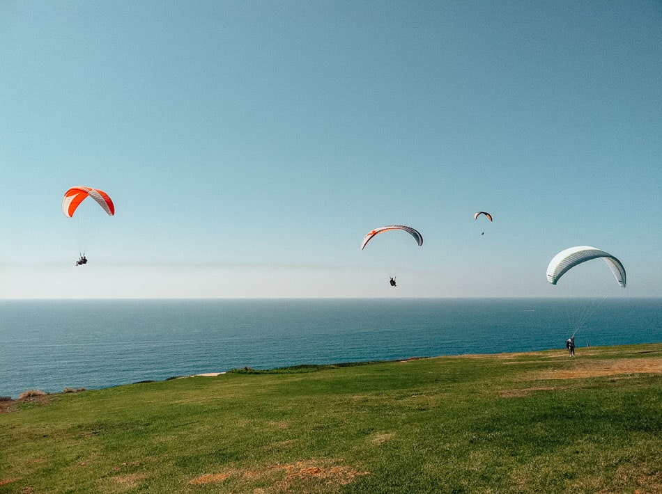 People paragliding at Torrey Pines Gliderport during a nice day in San Diego CA.