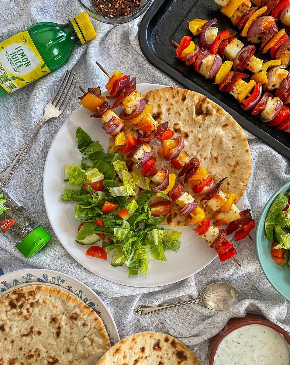 served skewers with bread and salad.