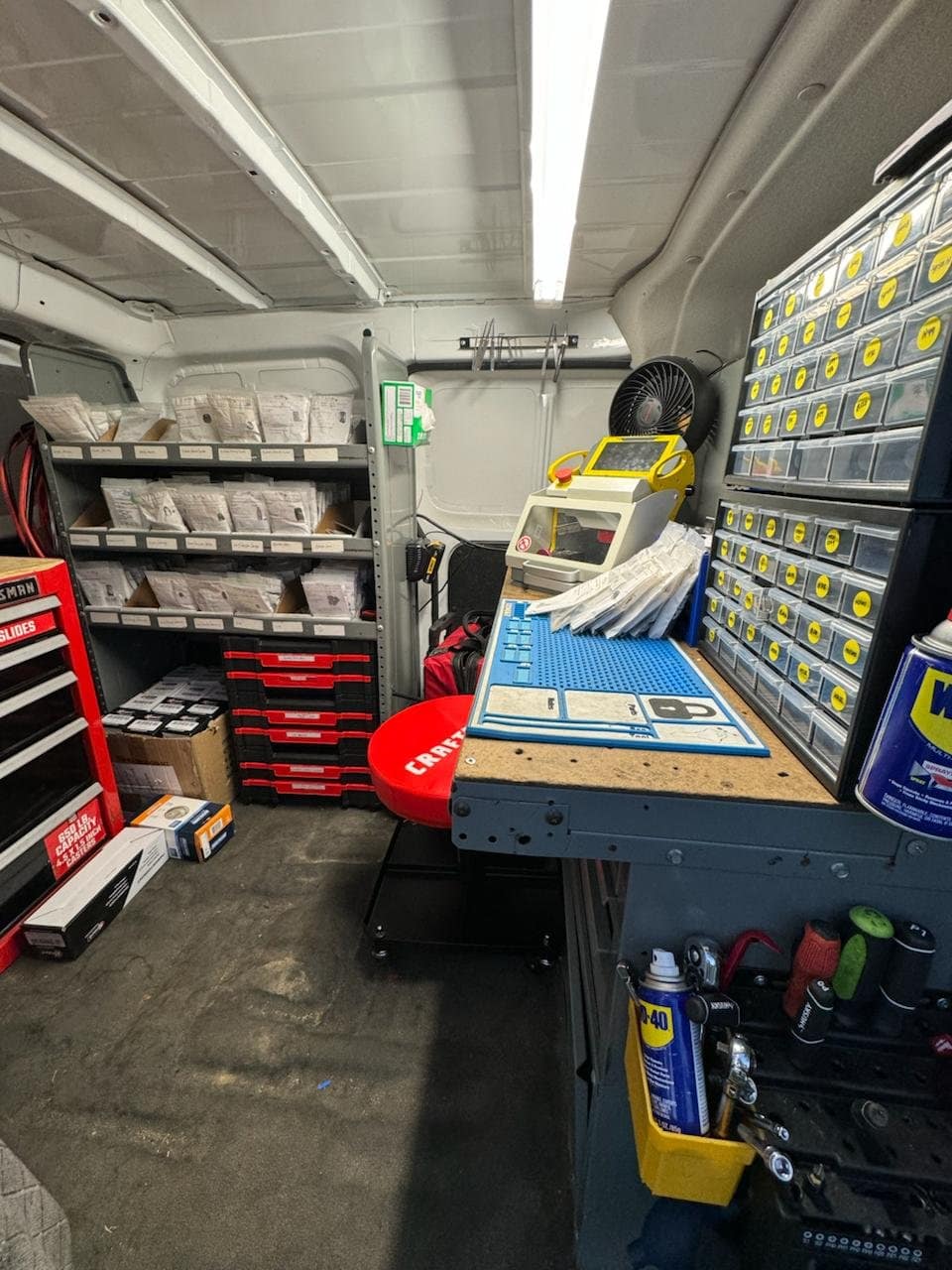 Mobile locksmith workbench with precision brass pinning kit and key blanks